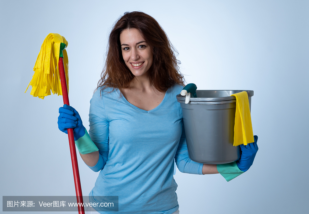 Beautiful happy housewife woman holding cleaning equipment. Proud women, Cleaning service Professional, housemaid and housework. Studio portrait isolated on blue background with copy space.